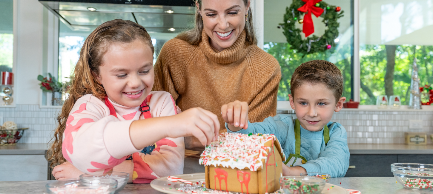 family making a gingerbread house together with C&H® baking tips